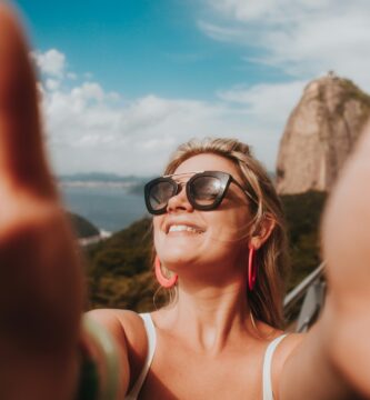 woman in white tank top wearing black sunglasses